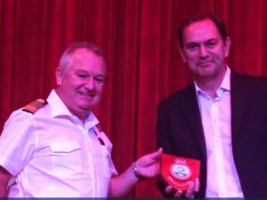 Captain hands a plaque to the Port representative